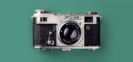 grey and black camera on green background